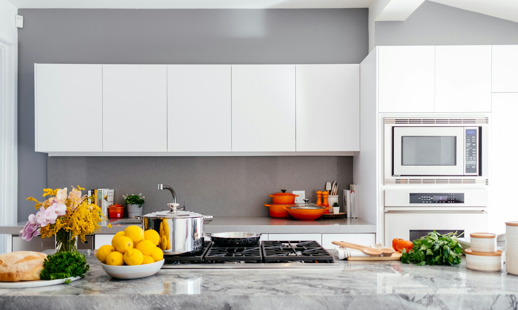 Custom kitchen cabinetry with stone island and integrated lighting
